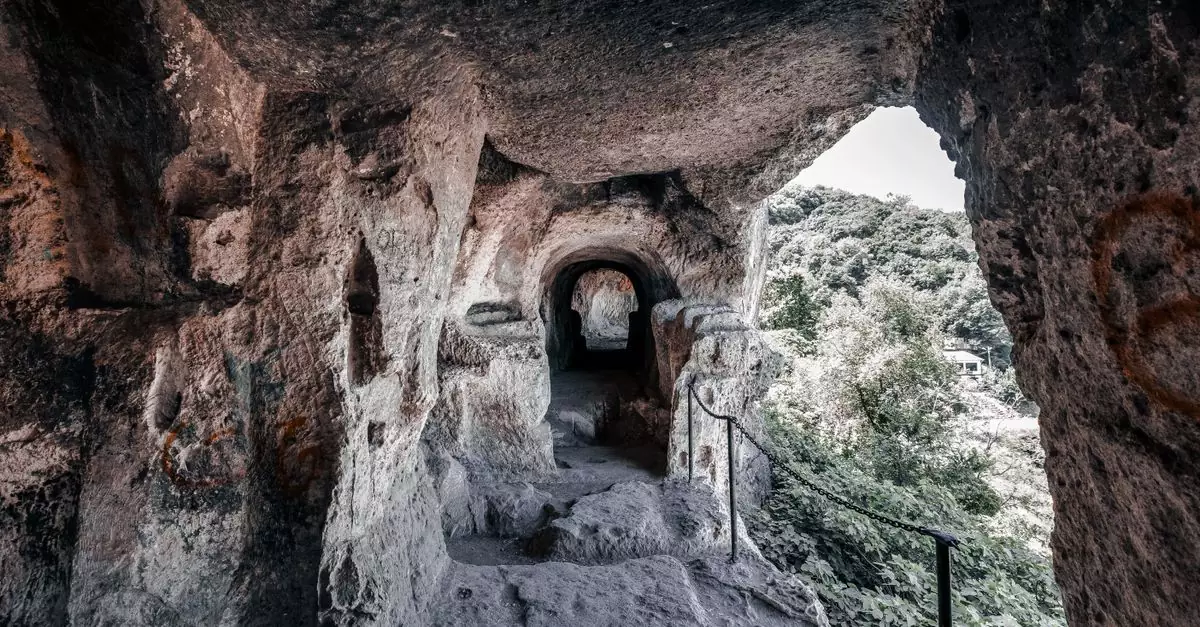 Explore an ancient rock cave passageway leading to nature, capturing a sense of mystery and history.