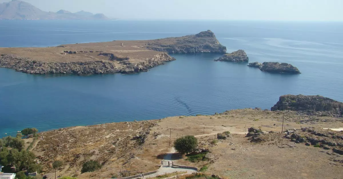 Aerial view of St. Paul's Bay in Rhodes, showcasing the rocky coastline and clear blue sea.