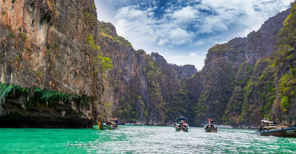 Explore the breathtaking cliffs and turquoise waters of Pi Leh Bay in Thailand, a popular travel destination.