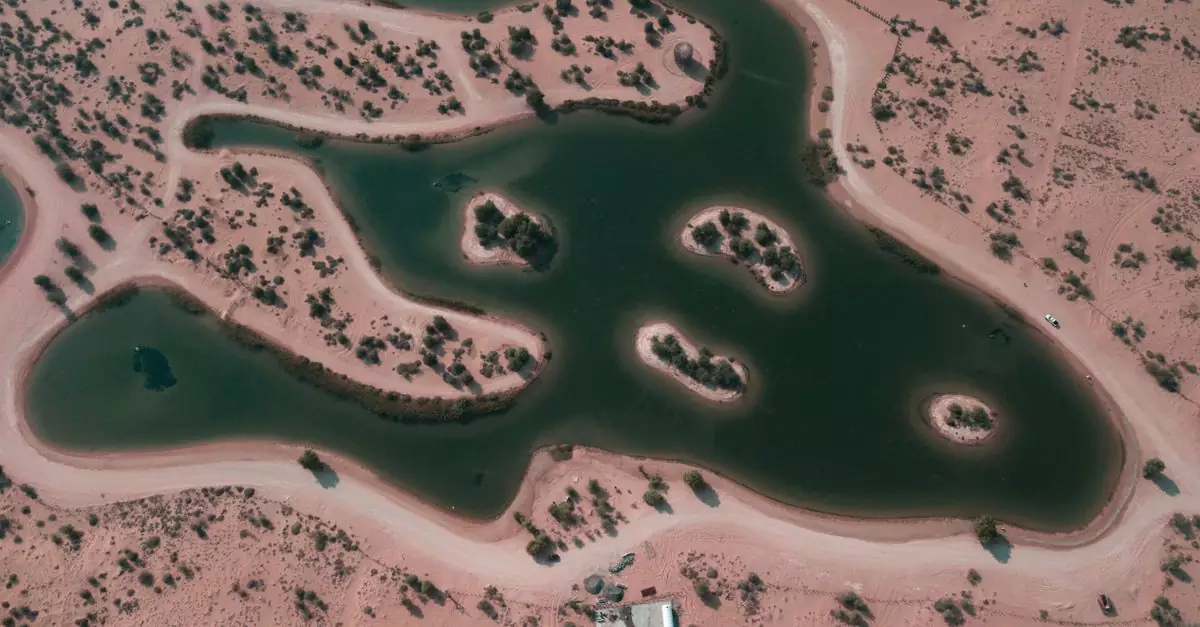 A striking aerial view showcasing the natural lakes surrounded by desert landscape in Dubai, UAE.