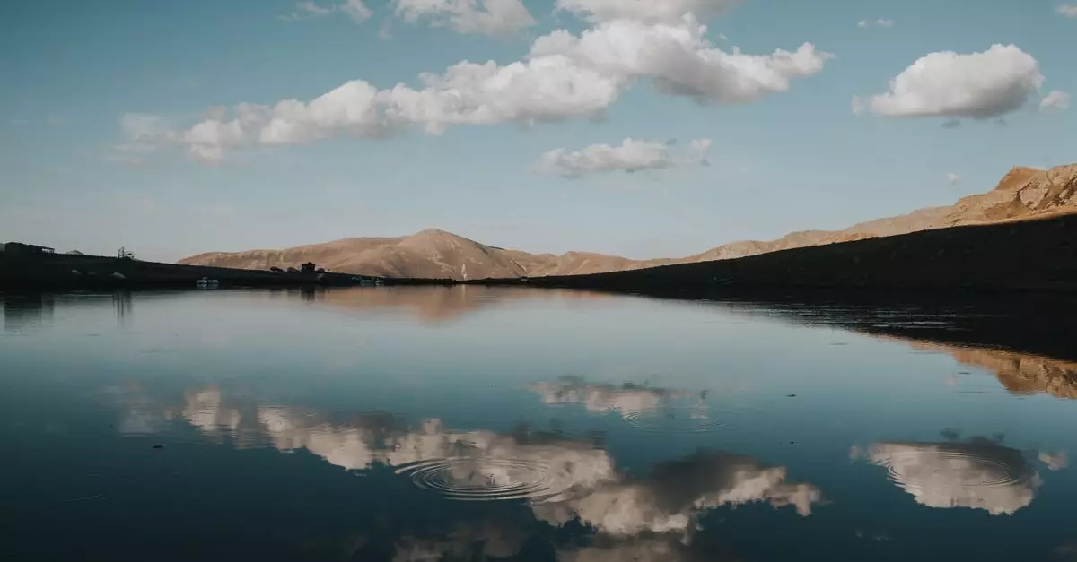 Serene lake with clouds reflected in water, showcasing Trabzon's natural beauty.