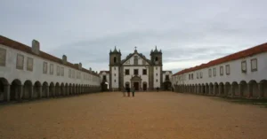 View of a historic church courtyard in Portugal, showcasing its architectural elegance.