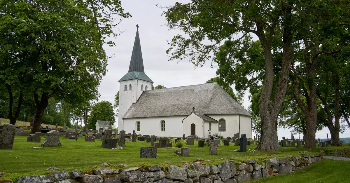 Whitewashed church in Torrskog, Sweden with stone cemetery and lush greenery.