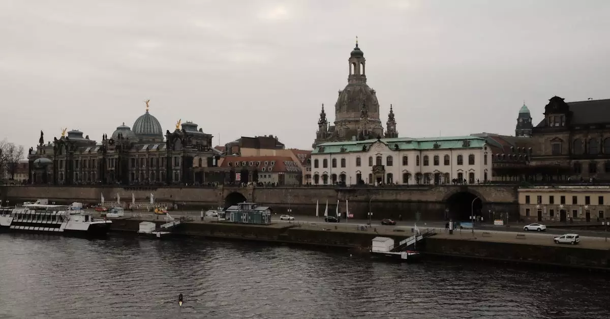 Scenic view of Dresden's architectural landmarks along the Elbe River on a cloudy day.