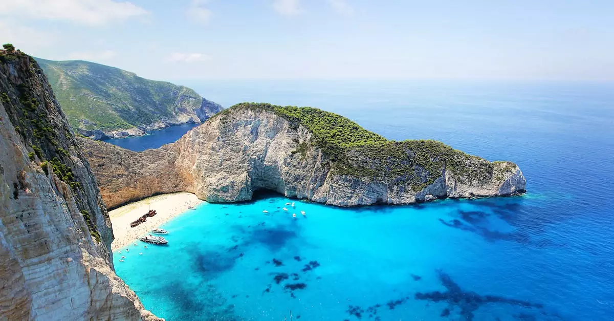 Stunning aerial view of Navagio Beach in Zakynthos, Greece, featuring turquoise water and a sunken ship.