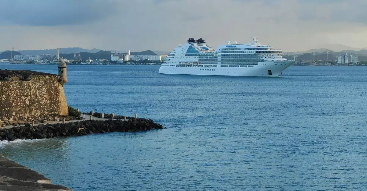 White cruise ship near historic San Juan fort, Puerto Rico at sunset.