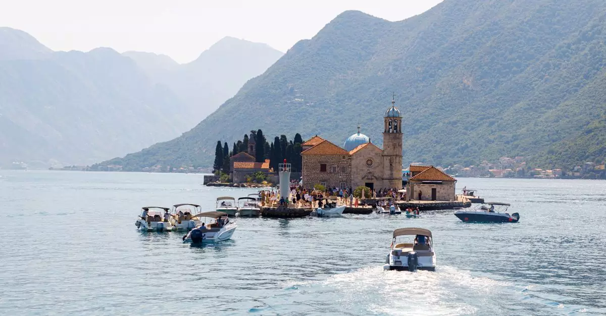 Scenic view of boats heading towards Our Lady of the Rocks island in Montenegro's Bay of Kotor.