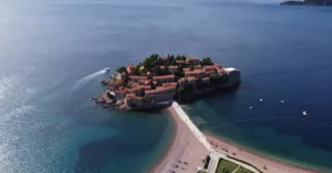 Breathtaking aerial view of the iconic Sveti Stefan island with clear Adriatic waters and coastal beauty.