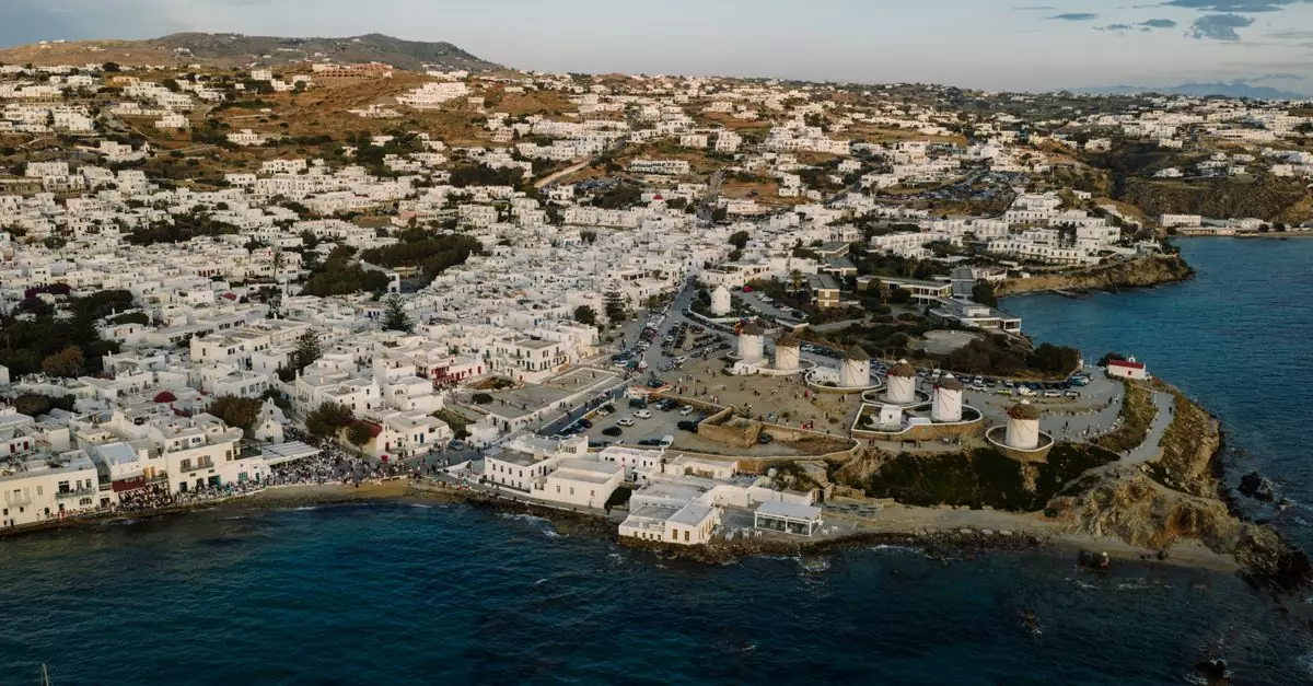 Stunning aerial shot of Mykonos town with its famous white buildings and windmills during daytime in Greece.