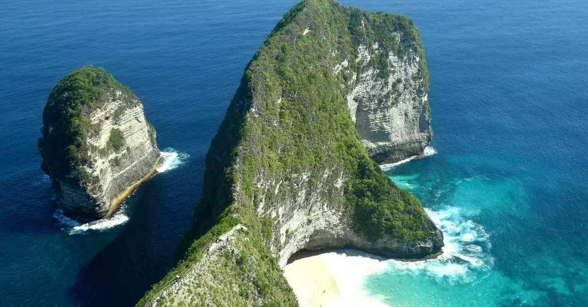 A breathtaking aerial shot of Kelingking Beach cliffs in blue ocean waters, Nusa Penida.