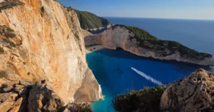 A breathtaking aerial view of Navagio Beach with turquoise waters against rocky cliffs in Zakynthos, Greece.