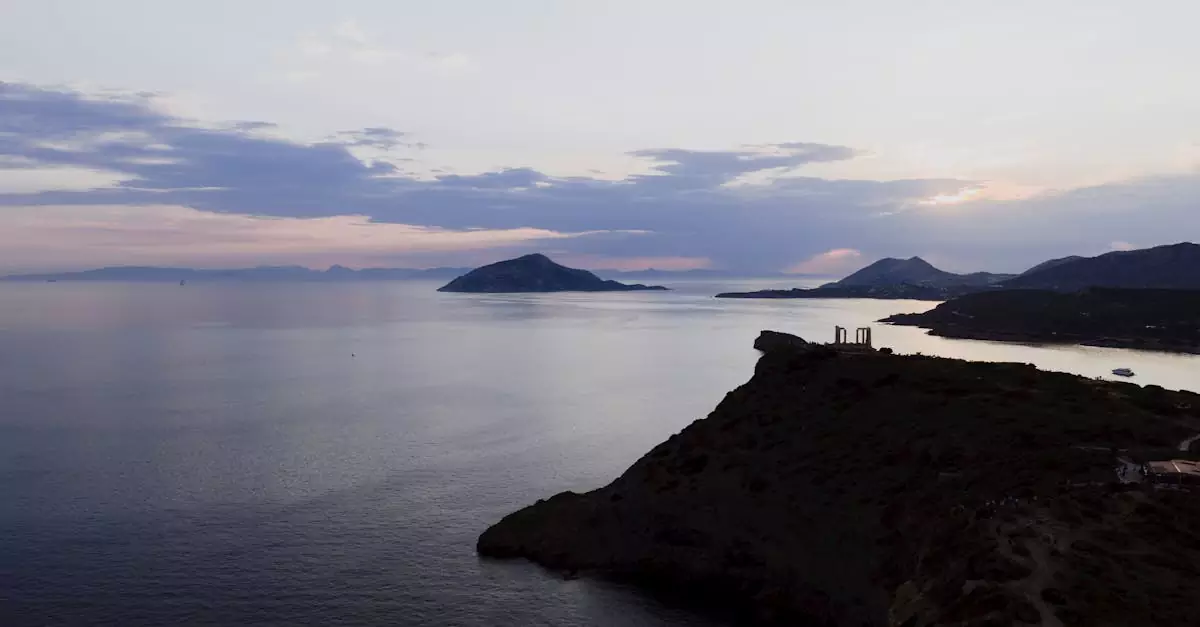 Stunning sunset at Cape Sounion with Temple of Poseidon overlooking the Aegean Sea.