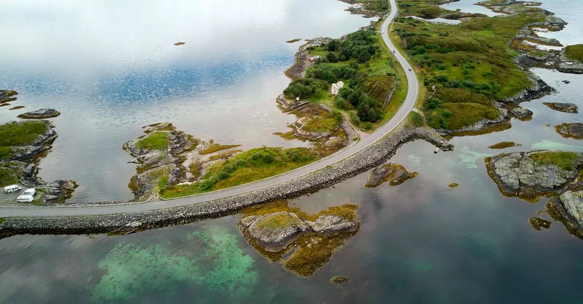 Aerial view of the famous Atlantic Ocean Road winding through Norway's scenic landscape.