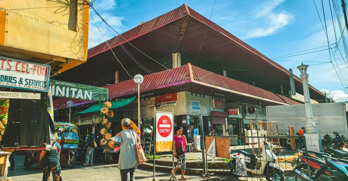 Lively street market scene in Dumaguete City, showcasing local vendors and vibrant culture.