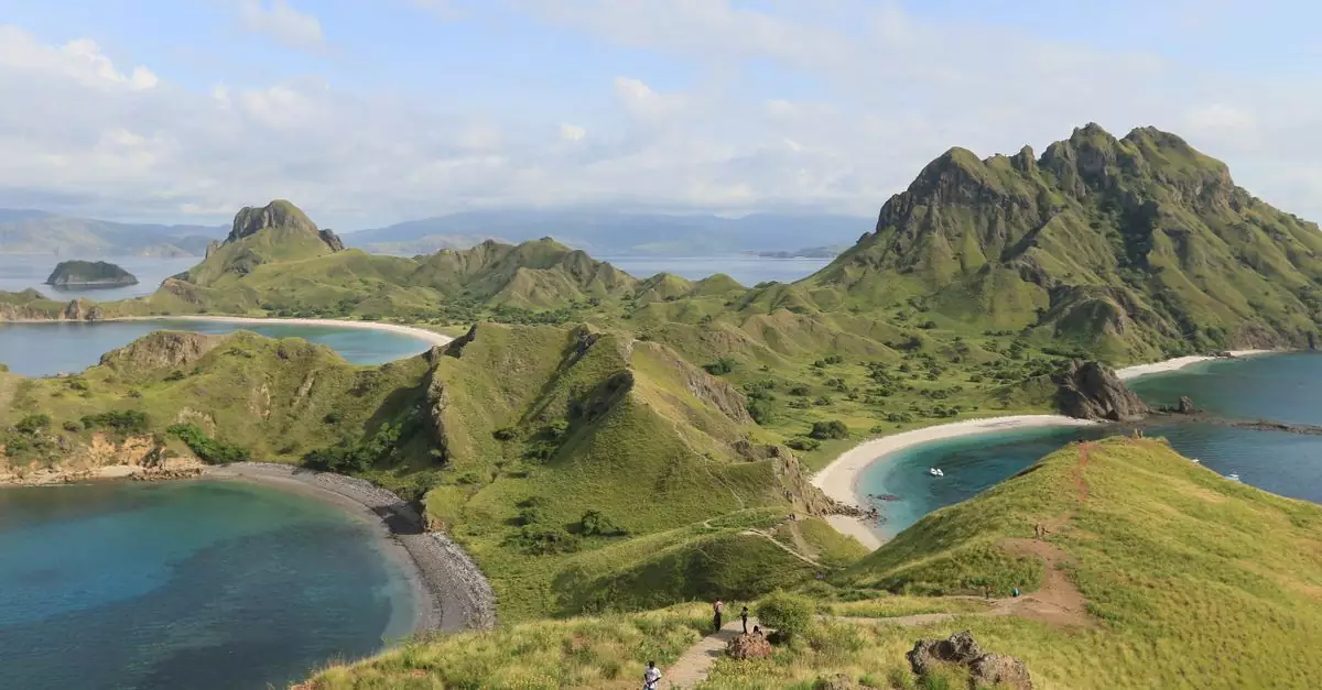 Scenic landscape of Padar Island in Indonesia, showcasing lush hills and turquoise waters.