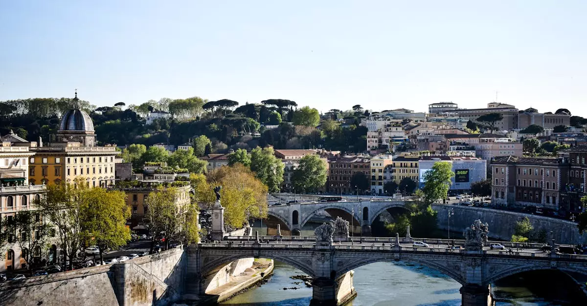 Beautiful view of Ponte Sant'Angelo spanning the Tiber River in Rome, Italy under a clear sky.