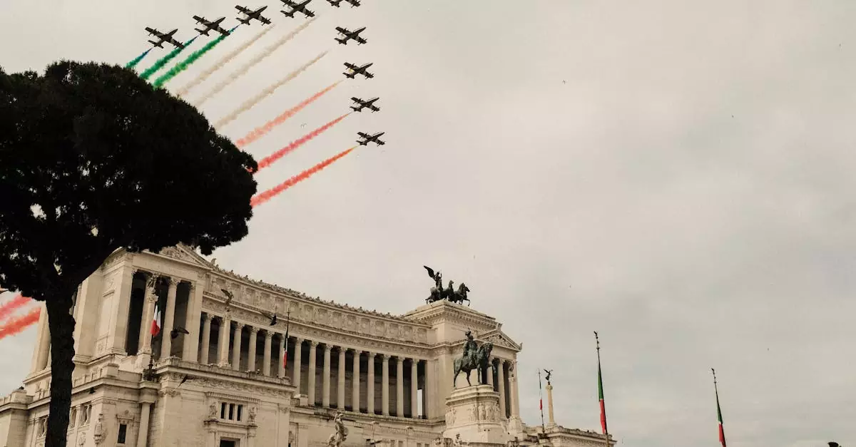 Low angle of air show over Victor Emmanuel Monument with sculptures and colonnade during National Unity and Armed Forces Day in Italy