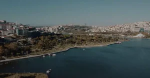 A scenic aerial view of Istanbul featuring its vibrant cityscape and tranquil waterfront under clear skies.