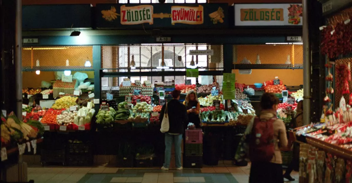 Vibrant scene inside Budapest's Central Market Hall with shoppers and colorful produce.