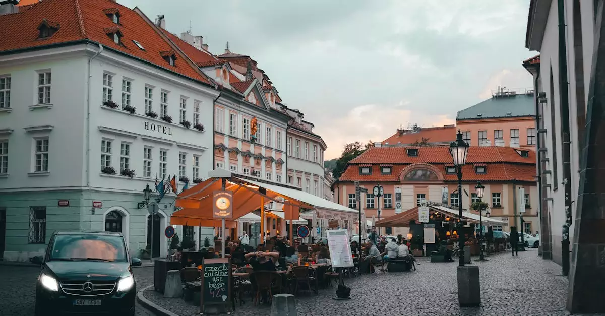 A picturesque evening view of a bustling cafe corner in Old Town Prague, Czechia.