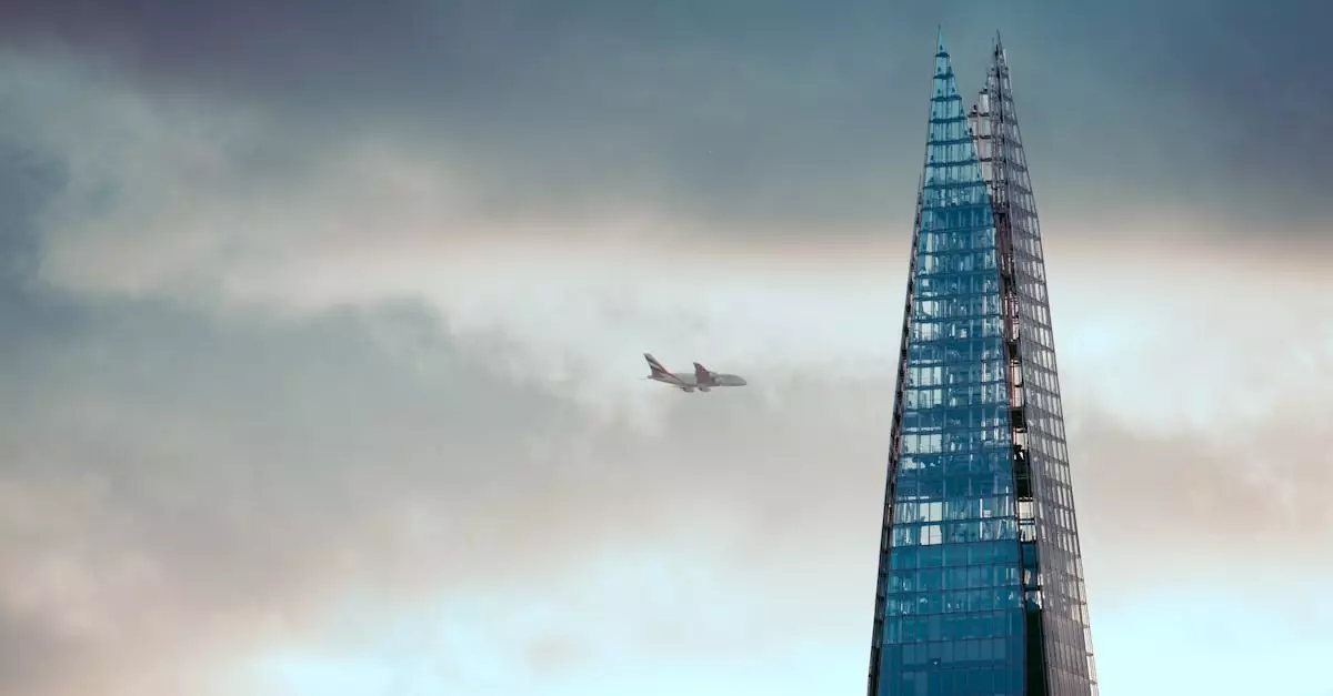 The Shard in London with an airplane soaring above against a dramatic sky.