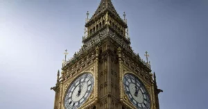 A close-up view of London's famous Big Ben clock tower under a clear blue sky.