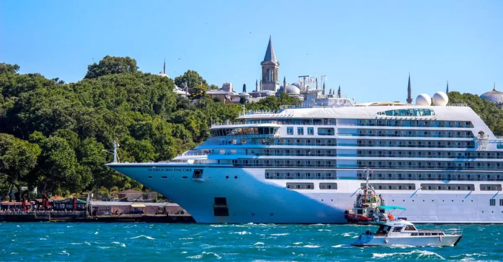 Best Luxury Cruises South America: Your Ultimate Guide 2 A majestic cruise ship sails through the Bosphorus Strait with a historic Istanbul skyline in the backdrop.