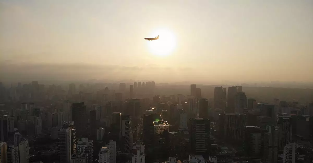 A stunning aerial view of São Paulo with an airplane flying over the city during sunset.