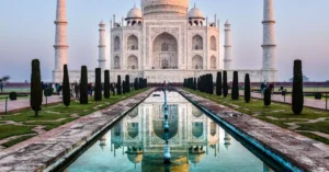 Stunning reflection of the Taj Mahal in Agra, India captured at sunrise.