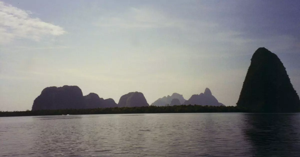 Peaceful view of Phang Nga Bay with limestone formations and calm sea in Thailand.