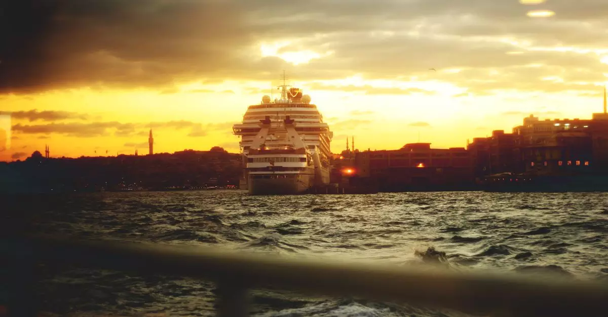 A stunning view of a cruise ship at sunset on the Istanbul coastline, capturing the vibrant sky and sea.