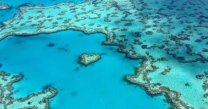 Stunning aerial photograph of the heart-shaped Great Barrier Reef in the Whitsundays, Australia.