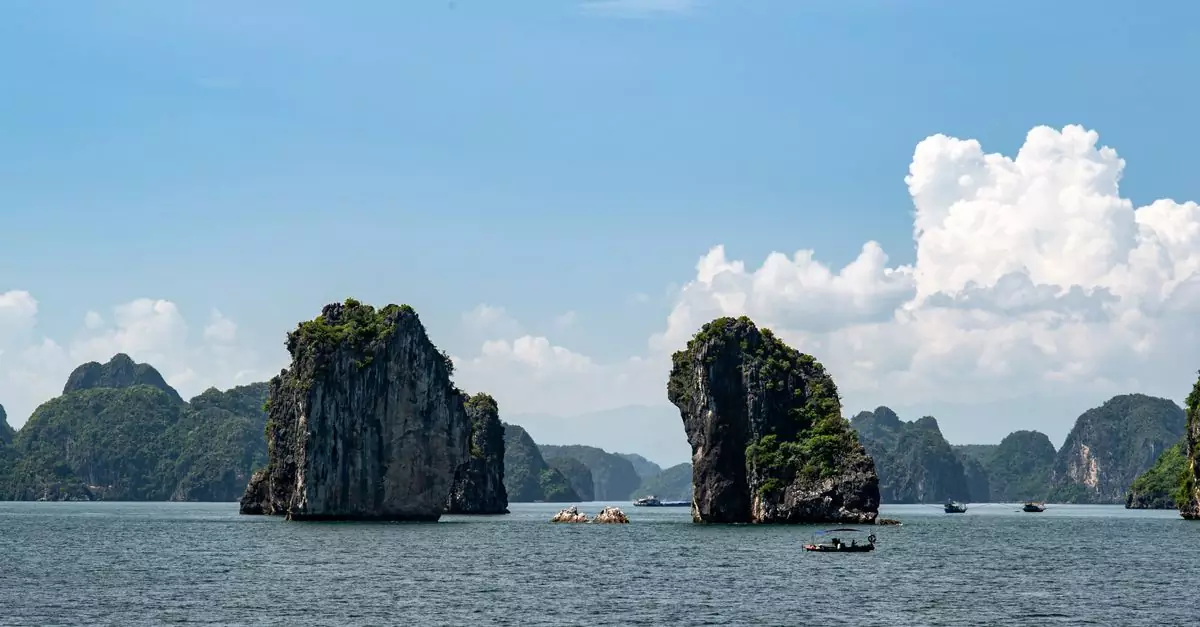 A beautiful view of limestone karsts in Halong Bay, Vietnam, under a clear blue sky.