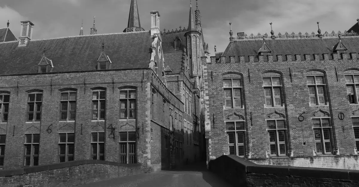 Explore the Gothic charm of Bruges with this black and white photograph of medieval architecture.