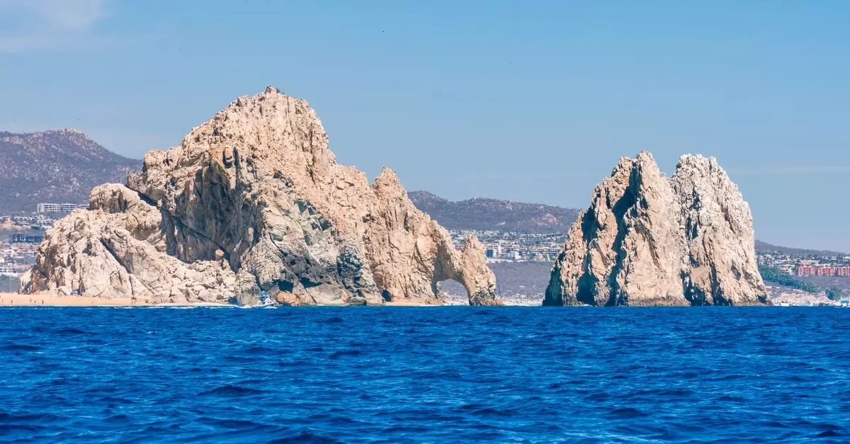 Breathtaking view of El Arco rock formations at Cabo San Lucas, under a clear blue sky.