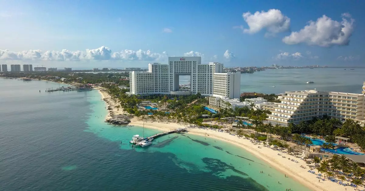 A stunning aerial view of a hotel on the Cancún beachfront, showcasing the coastline and sea.