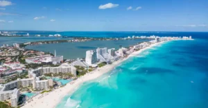 Beautiful aerial view of Cancun's coastline with clear blue waters and luxury resorts.