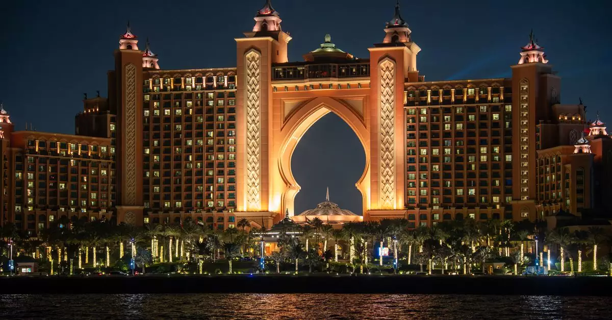 Stunning night view of Atlantis The Palm hotel in Dubai, UAE, glowing with warm lights.