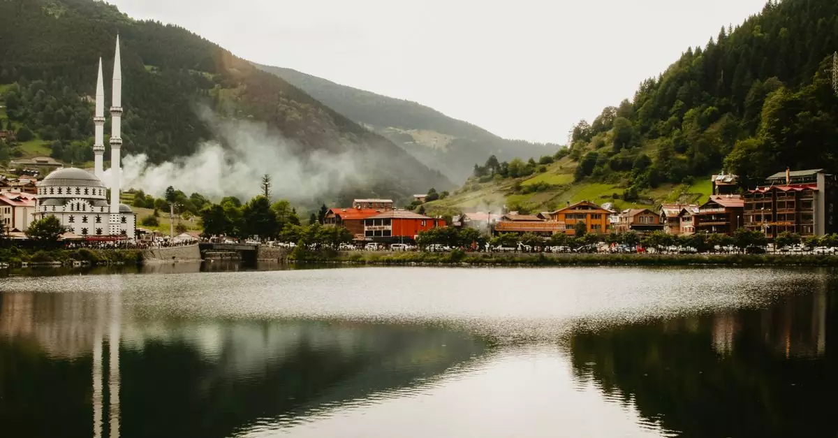 Idyllic view of Uzung&ouml;l town with its iconic mosque and serene lake surrounded by lush hills.