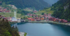 Scenic view of Uzungöl village by the lake with lush green mountains in Trabzon, Turkey.