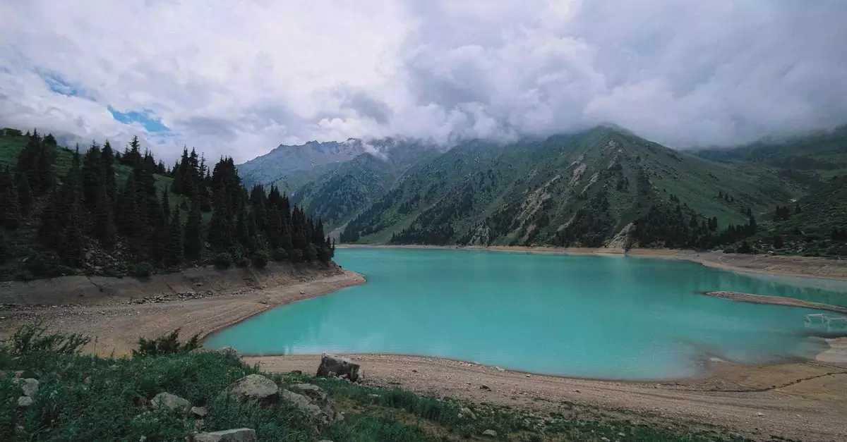 A breathtaking aerial view of Big Almaty Lake amidst majestic mountains and lush forests in Kazakhstan.