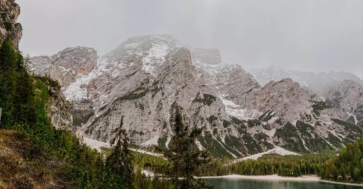 Breathtaking view of Dolomites mountains and serene lake in Veneto, Italy during early winter.