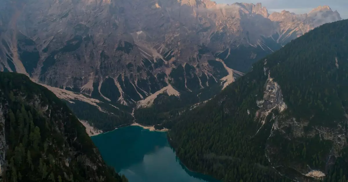 Stunning aerial photo of Lago di Braies surrounded by Dolomites mountains. Captivating natural beauty.