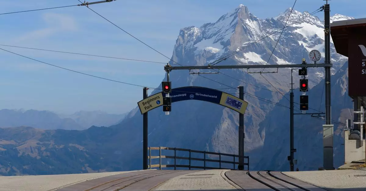 Scenic view of train station with Swiss Alps in the background. Perfect for travel enthusiasts.