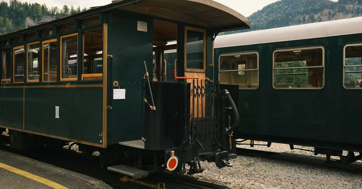 A vintage train carriage parked at a mountain station, showcasing scenic views and historic charm.