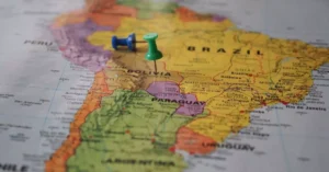 Close-up of a map of South America with pins marking locations in Brazil and Bolivia.