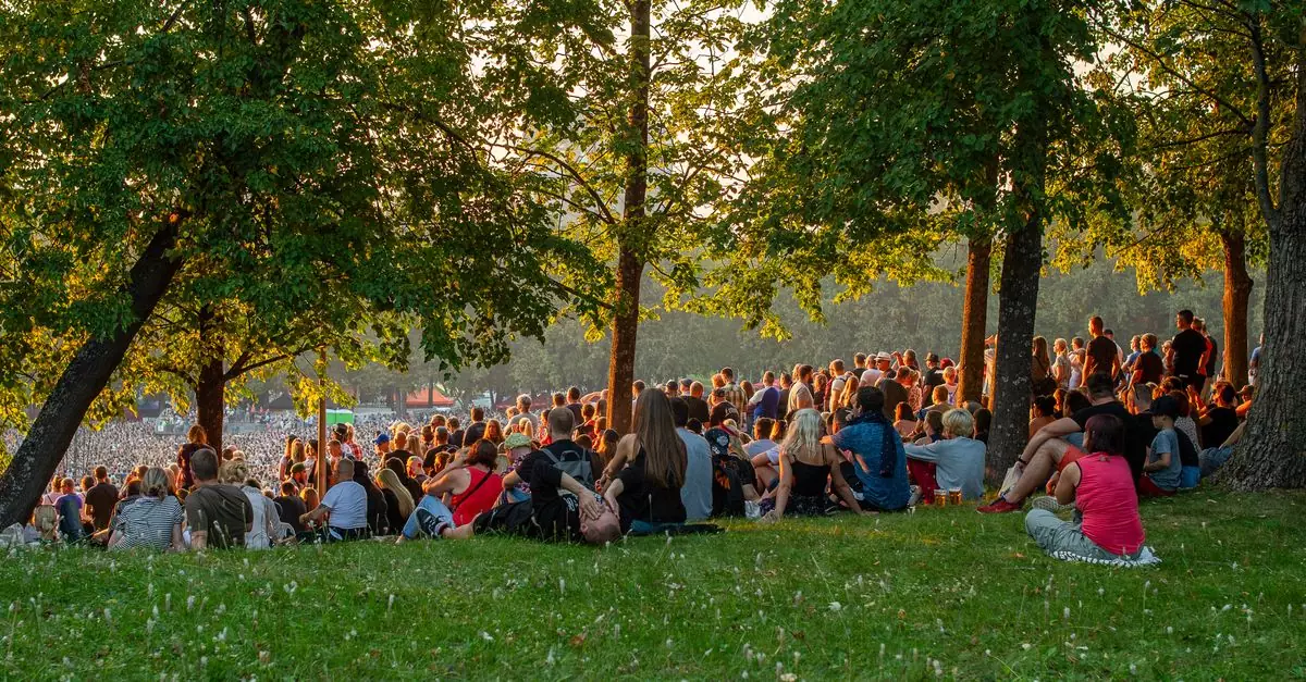 A large crowd enjoys live music during a summer evening at Tallinn Song Festival Grounds.