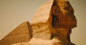 Majestic view of the Great Sphinx and Pyramid in Egypt, showcasing ancient architecture.