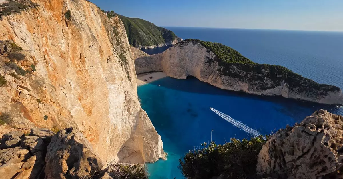 A breathtaking aerial view of Navagio Beach with turquoise waters against rocky cliffs in Zakynthos, Greece.