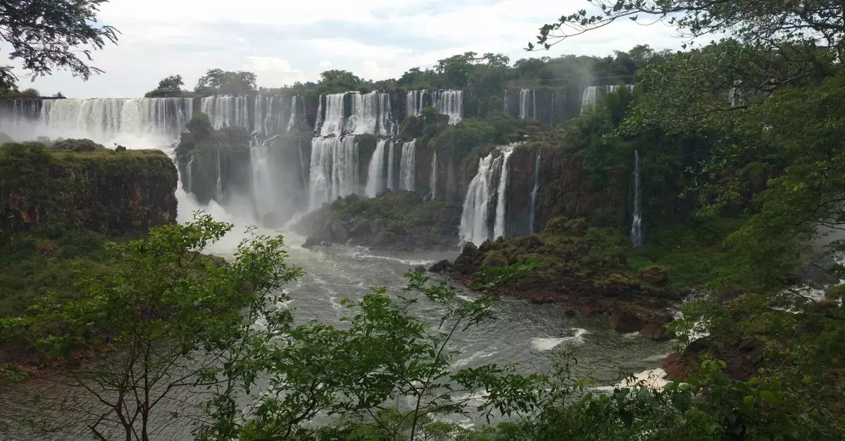 Stunning view of Iguazu Falls cascading through lush greenery in Misiones Province, Argentina.